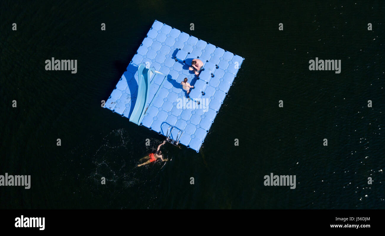 Bathers use a swimming platform at the Natural Pool City Park Lake in Hamburg, Germany, 17 May 2017 (aerial picture shot with a drone). The company Baderland announced that the the pools in Billstedt and the Kaifu-pool opened their doors to visitors along with the Natural Pool. Photo: Axel Heimken/dpa Stock Photo