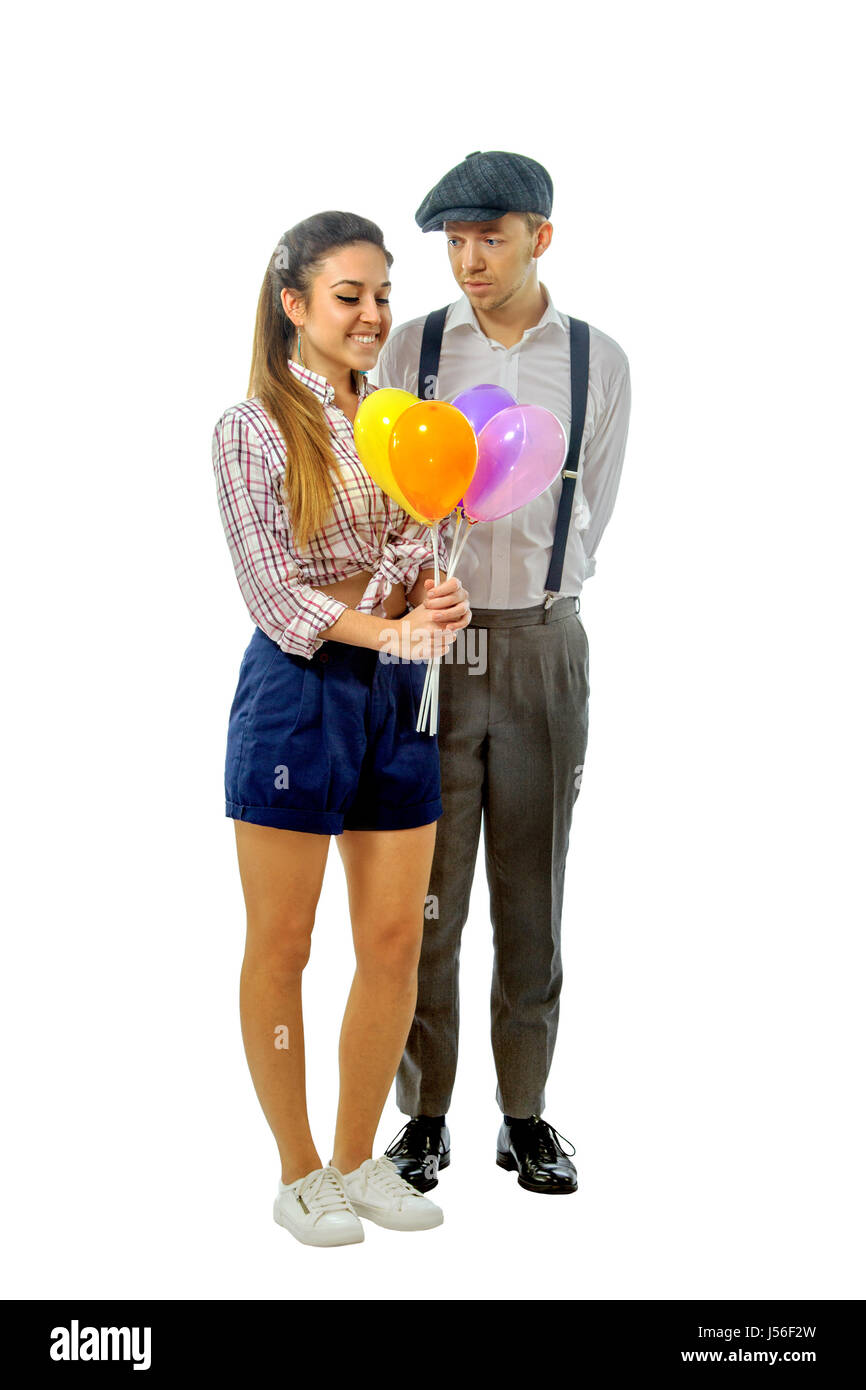 image of a young man in a cap gave the girl balloons Stock Photo