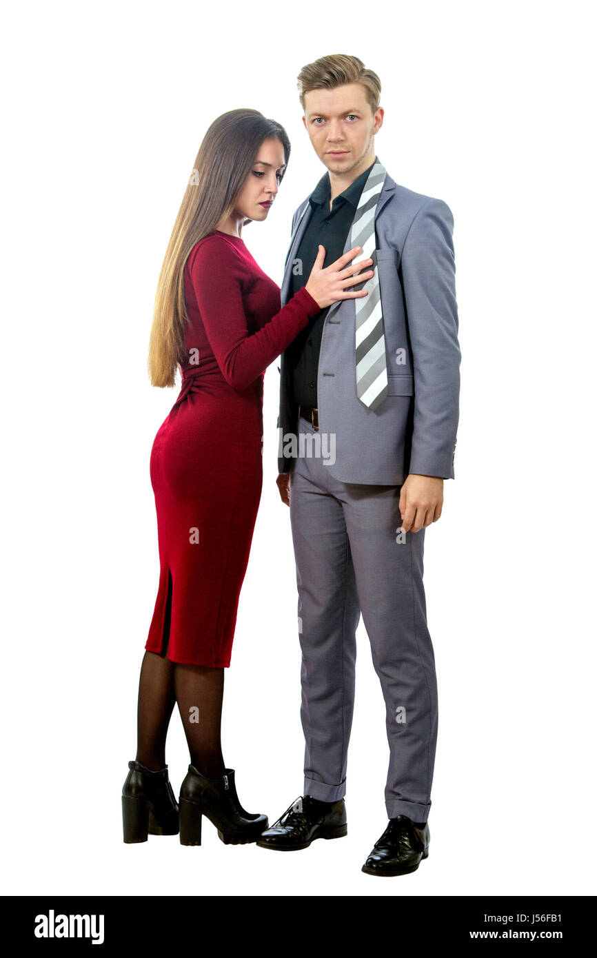 a young man in a jacket and tie with a beautiful girl in a red dress Stock Photo