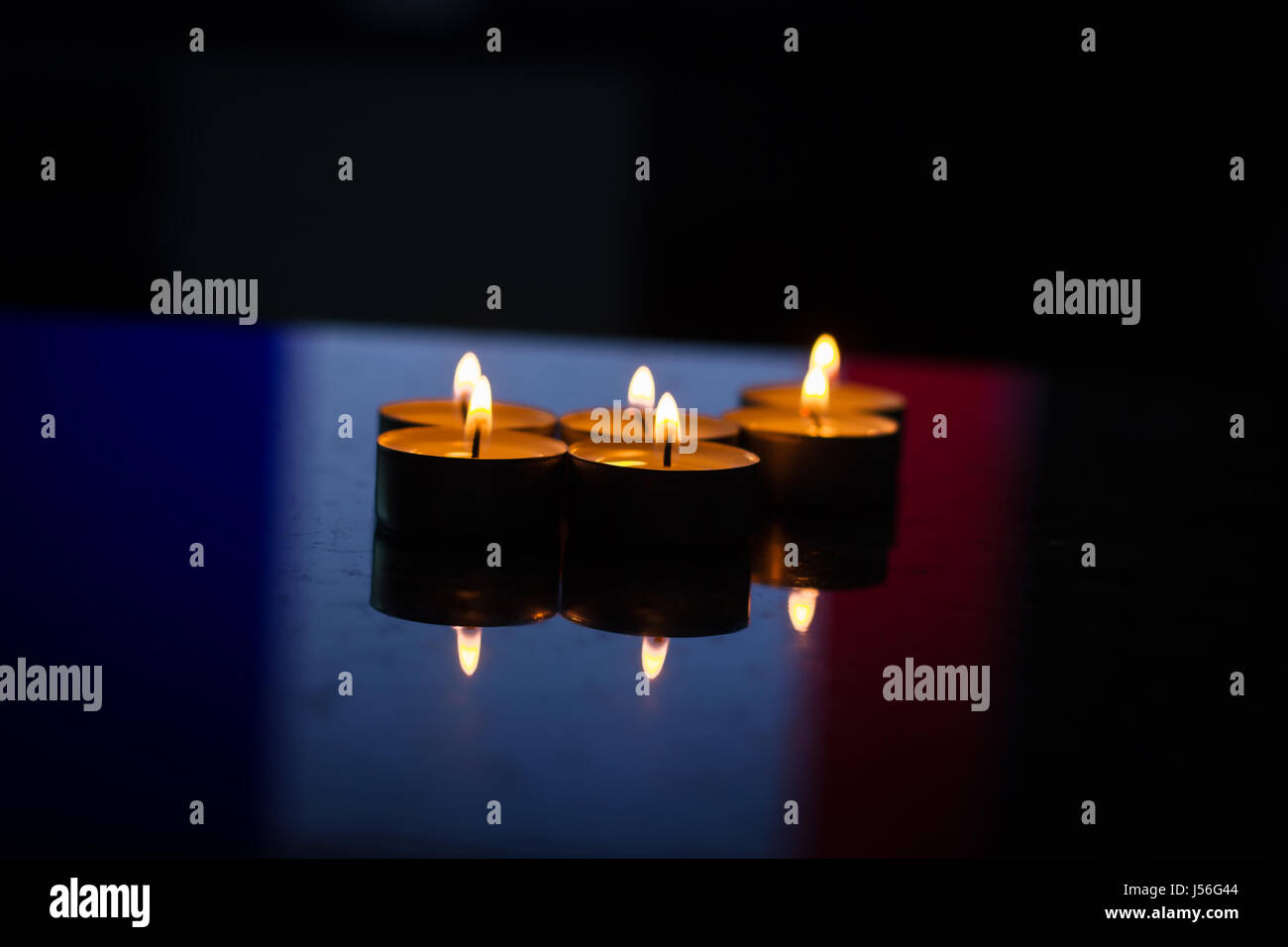 burning candles in front of french flag in solidarity with victims Stock Photo Alamy