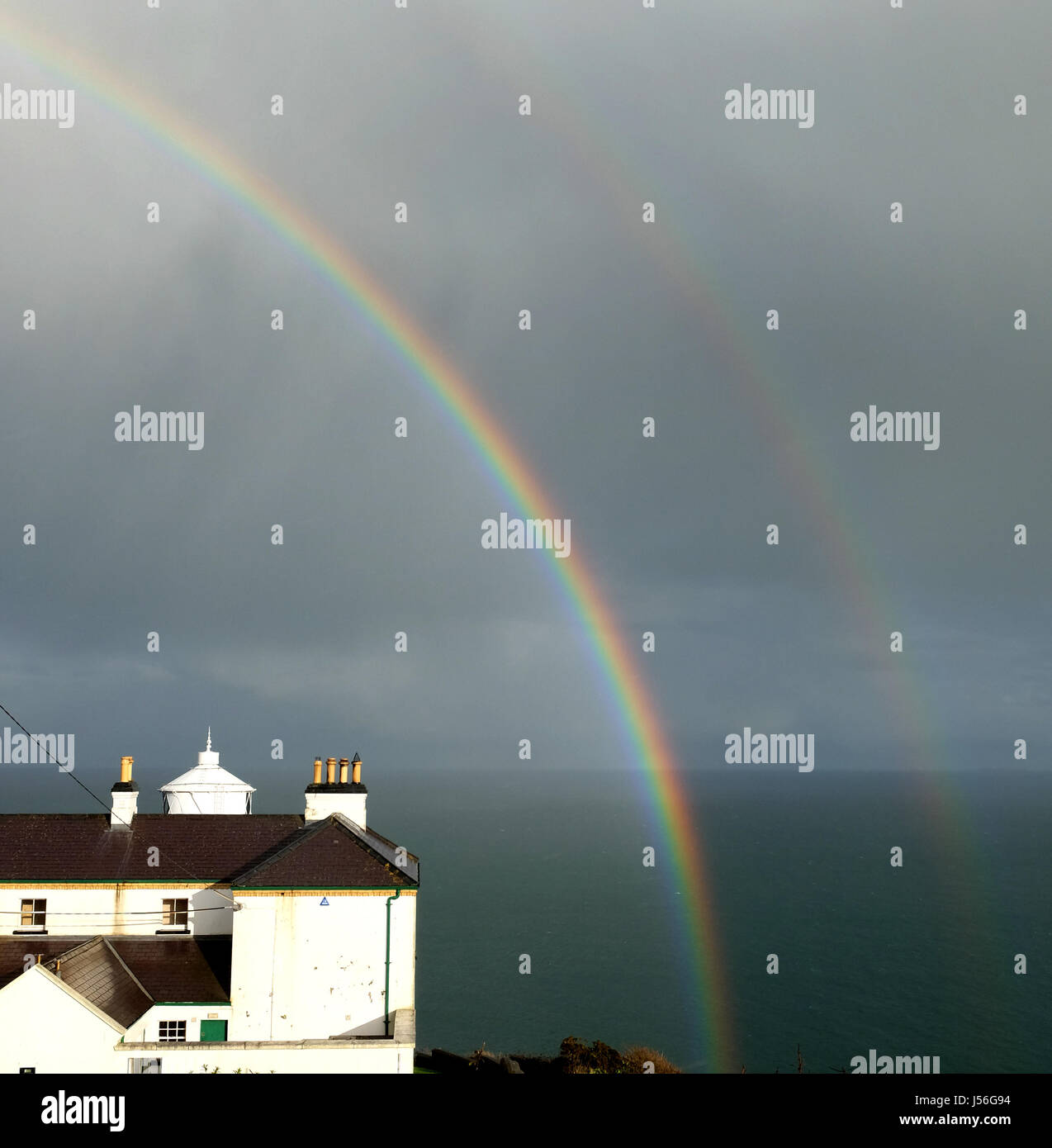 Rainbows over Blackhead Lighthouse. Stock Photo