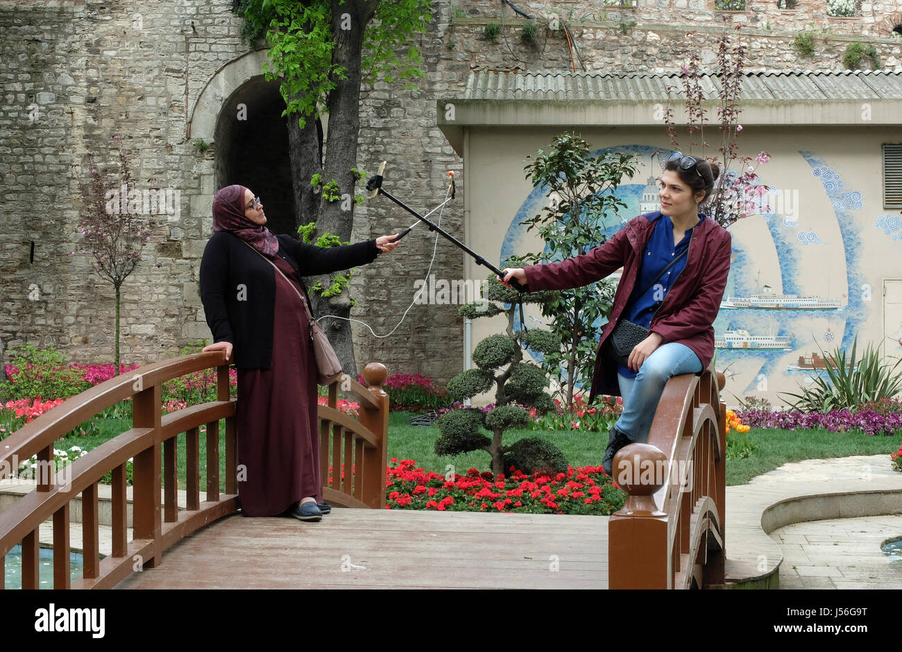 Two women take 'selfies' in Gülhane Park , Istanbul Stock Photo