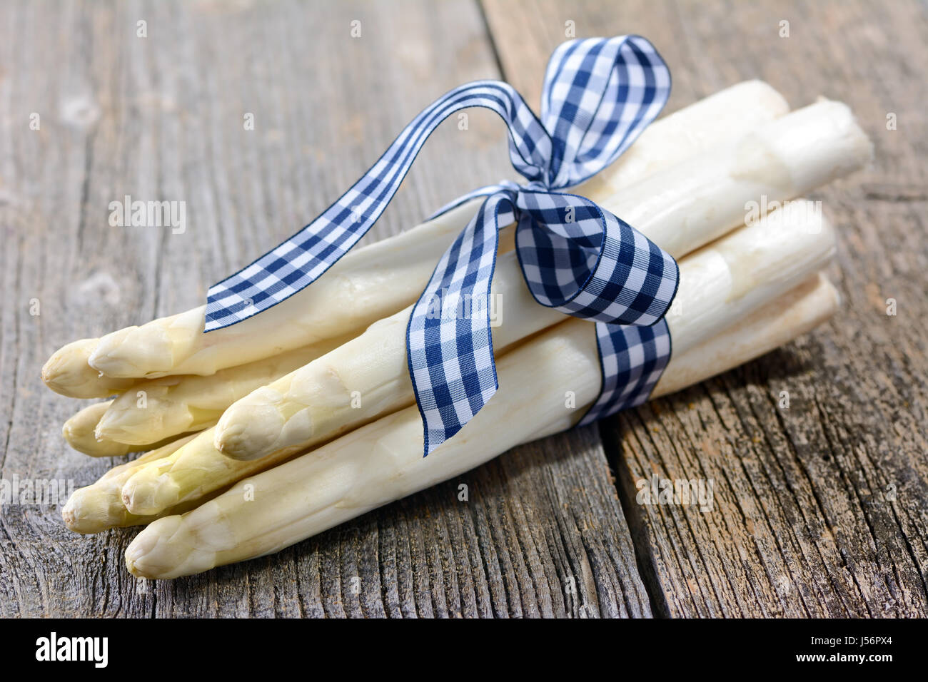 A bunch of white asparagus from Germany on a wooden table Stock Photo