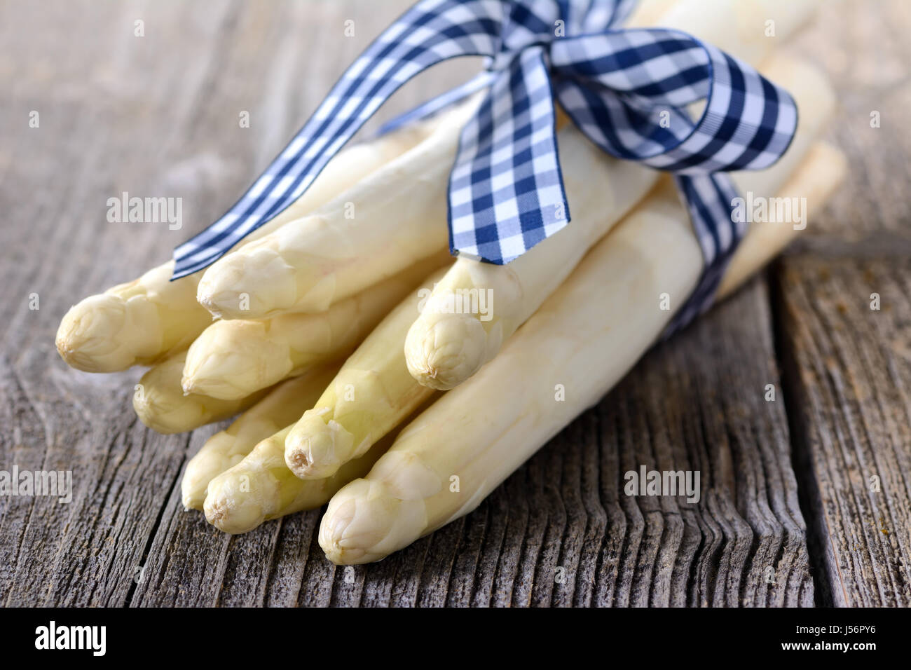 A bunch of white asparagus from Germany on a wooden table Stock Photo