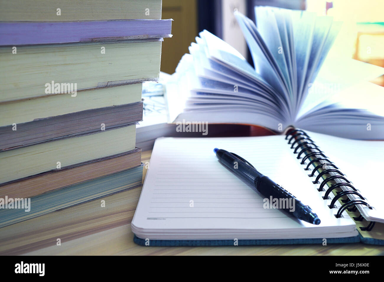 Education and learning concept. Book opened, stack of books and ...