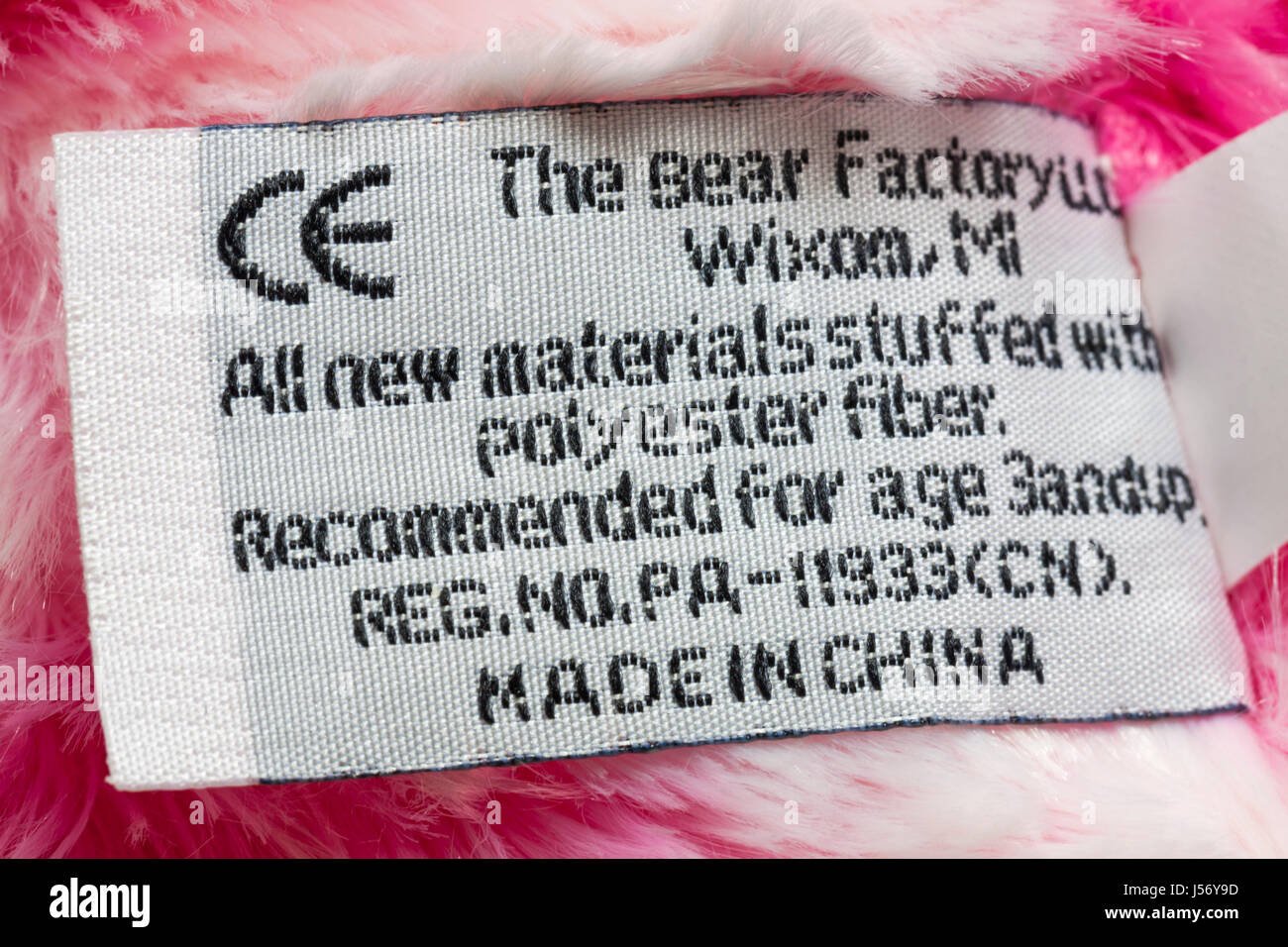 Label in pink and white bear by The Bear Factory made in China, all new materials stuffed with polyester fiber, recommended for age 3andup, CE symbol Stock Photo