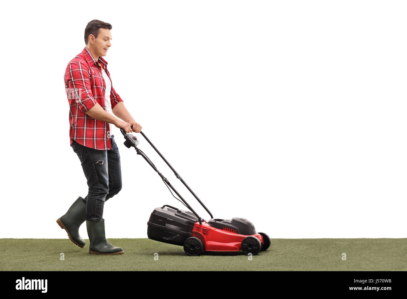 Full length profile shot of a gardener mowing a lawn with a lawnmower isolated on white background Stock Photo