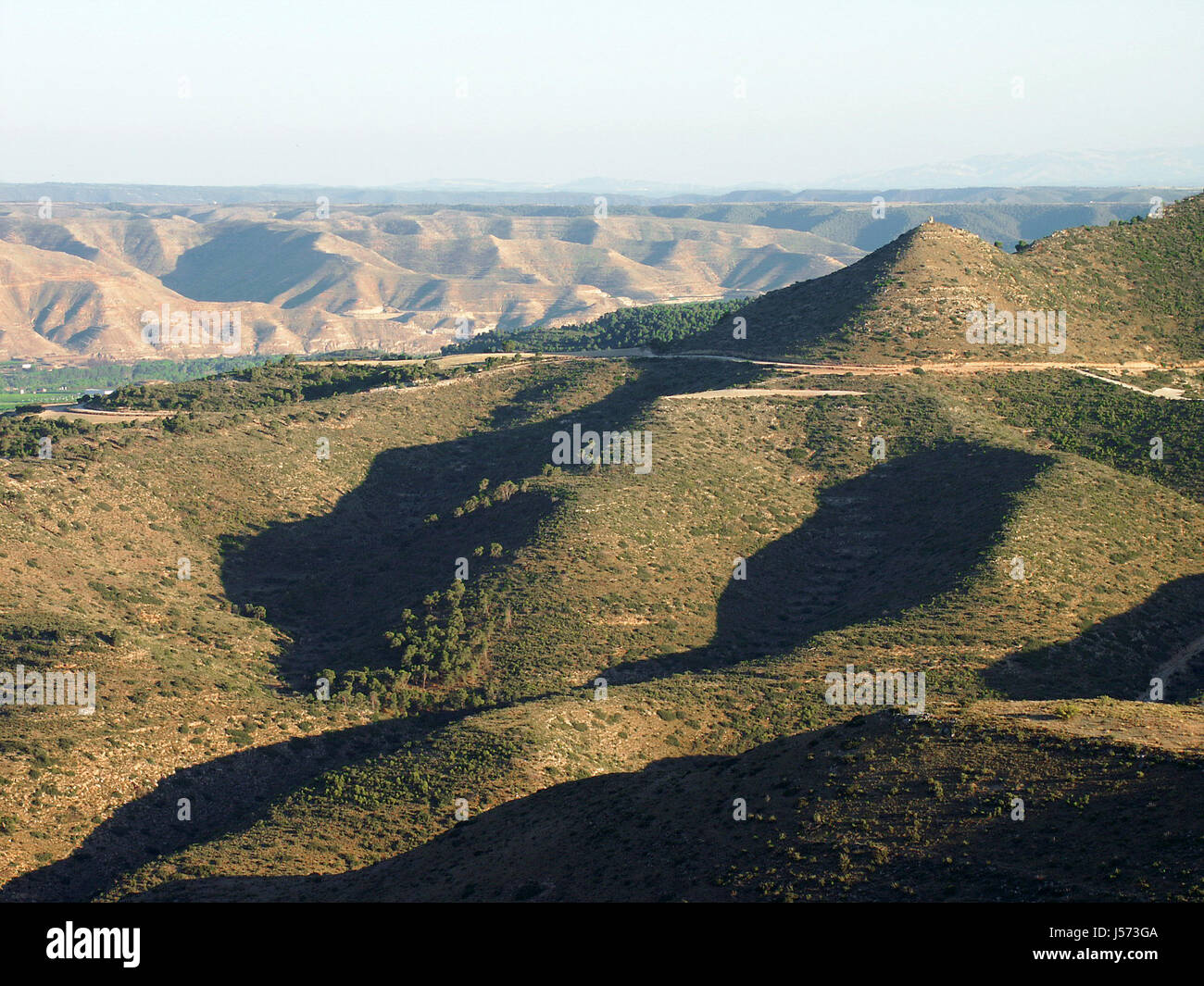 hill mountains spain valley evening light setting sun plastic structure Stock Photo