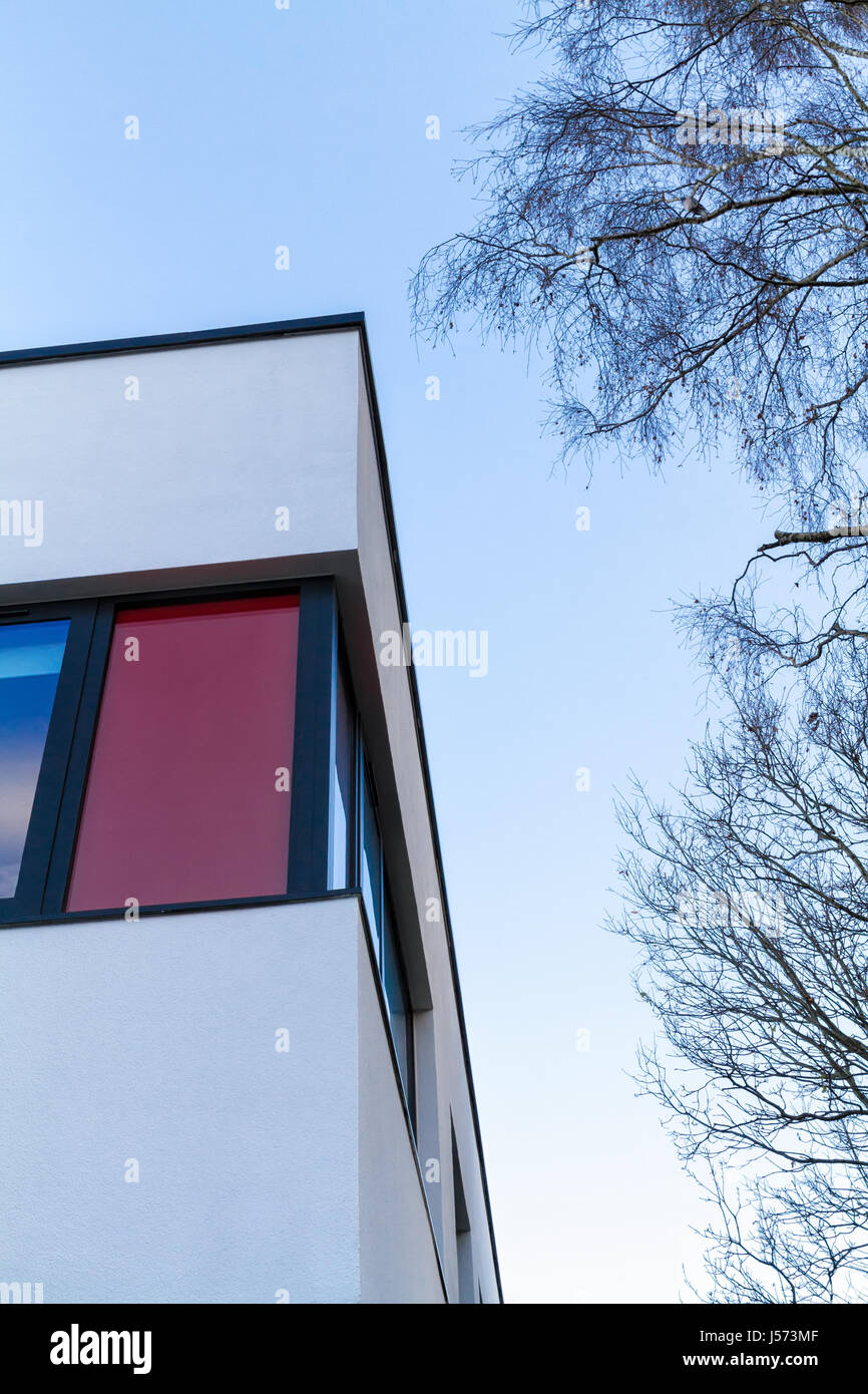 Red and white rendered modern building facade on a bright sunny day ...