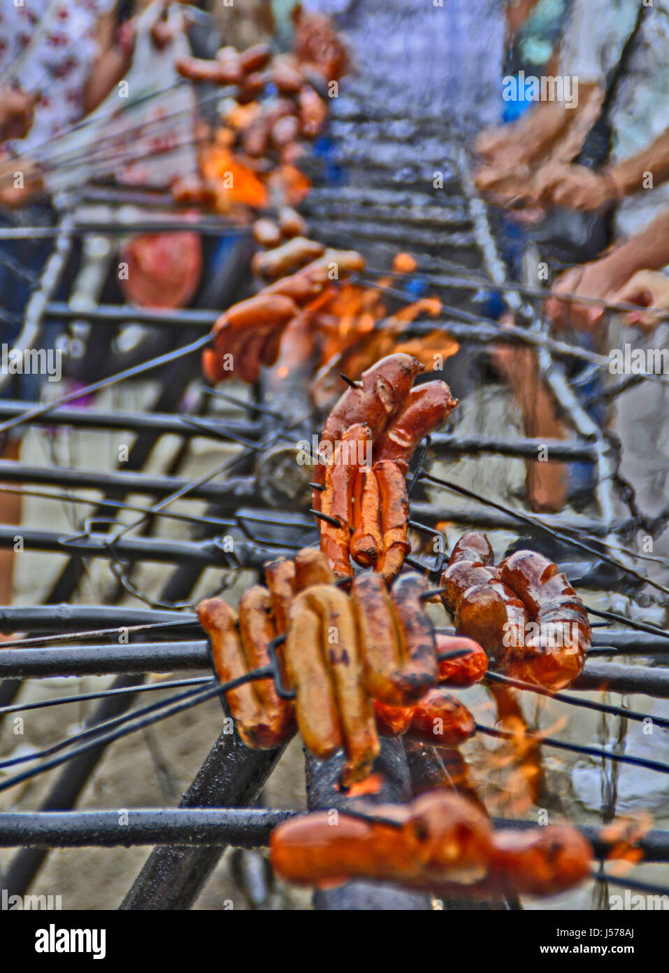 Traditionally street roast sausages on fire during the celebrations. Stock Photo