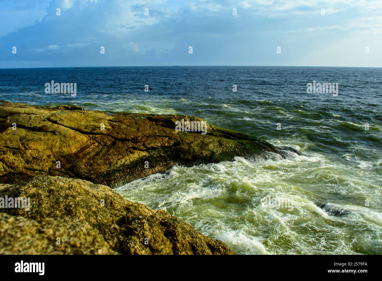 Waves washing ashore over rocks, Indian Ocean Stock Photo - Alamy