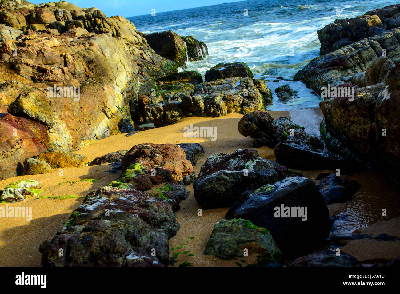 Waves washing ashore over the rocks Stock Photo - Alamy