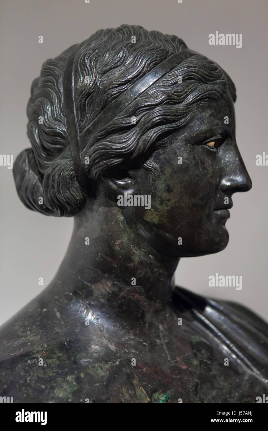 Bronze bust of Greek poetess Sappho. Roman copy from the 1st century AD after a Greek original found in the rectangular peristyle in the Villa dei Papiri (Villa of the Papyri) in Herculaneum on display in the National Archaeological Museum in Naples, Campania, Italy. Stock Photo