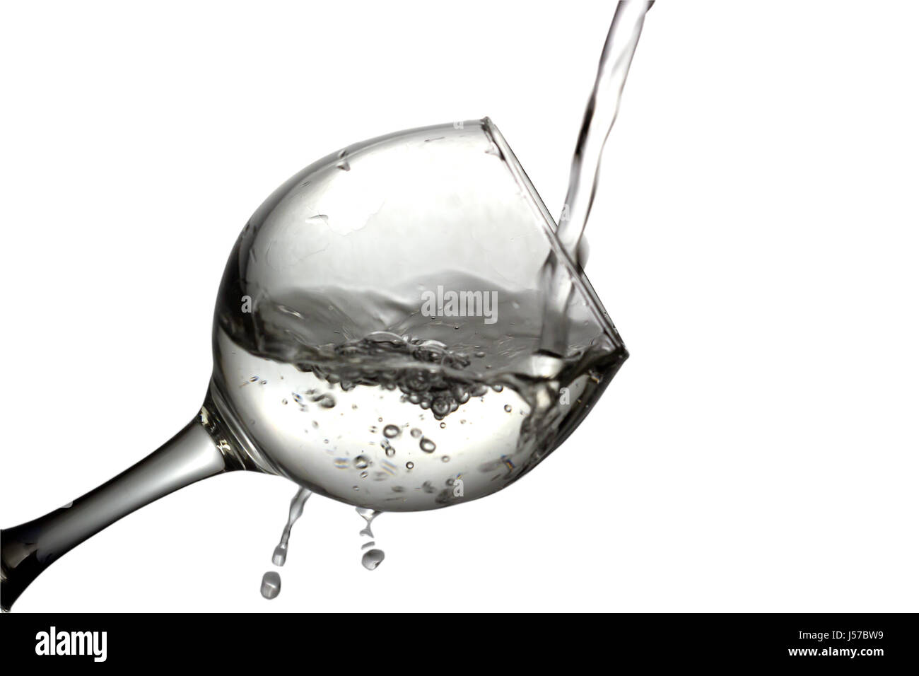 Colorless liquid, water,vodka is poured into a glass, liquid in a ...