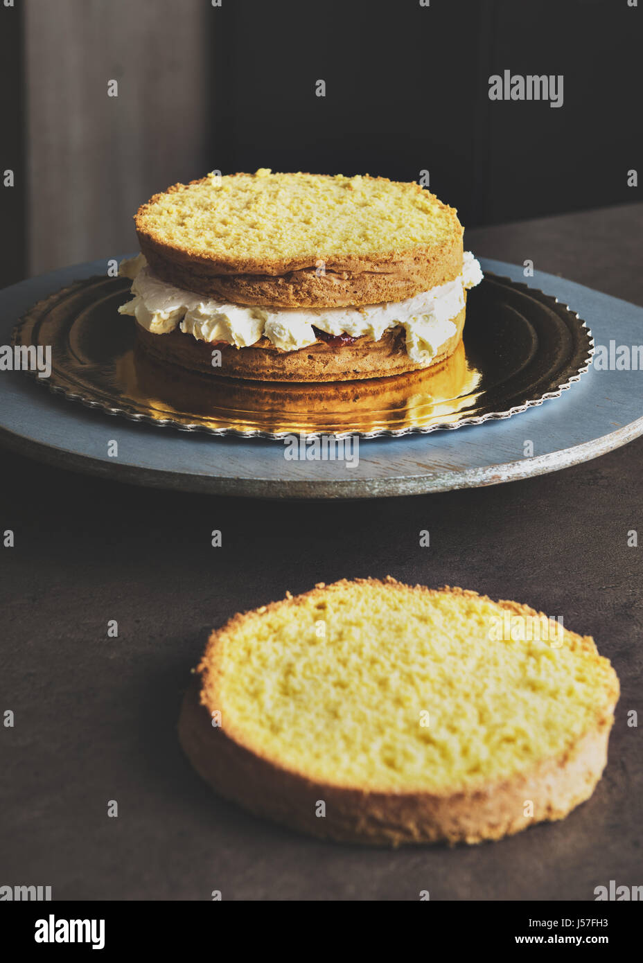 Delicious sponge cake filled with butter cream and decorated with frosting Stock Photo