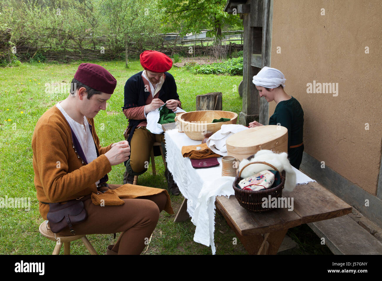 Sewing by a reenactment group, reconstructed medieval house, Nienover, Bodenfelde, Lower Saxony, Germany Stock Photo