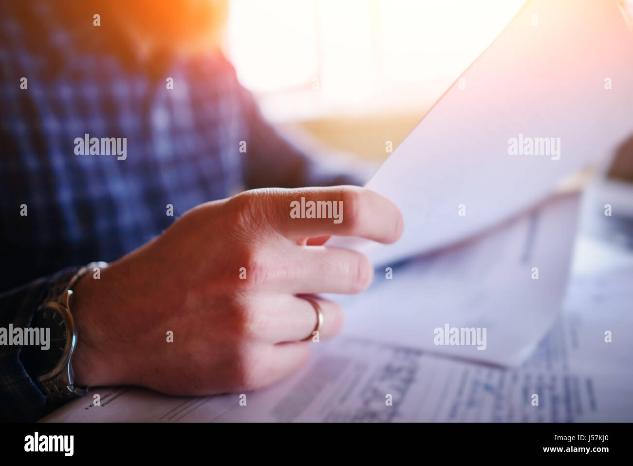 Handsome man working at home in the kitchen. Stock Photo