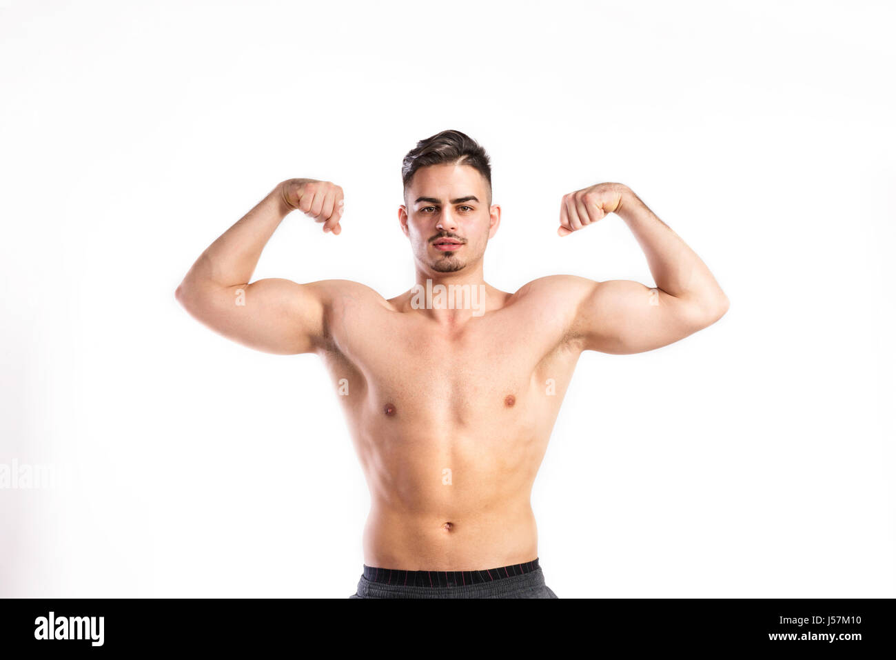 Shirtless fitness man flexing his arms. Studio shot Stock Photo Alamy