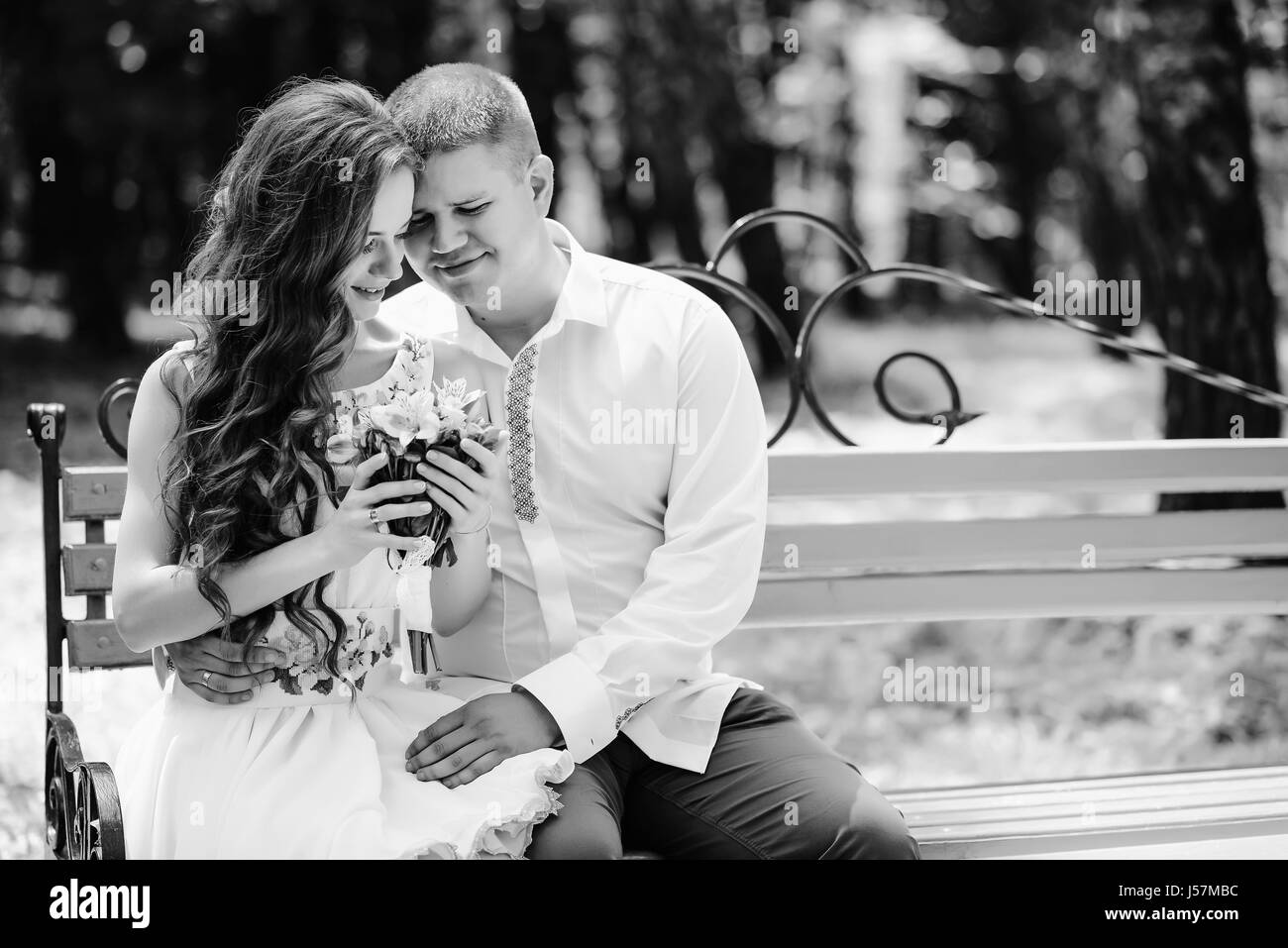 The bride and groom sit on a bench black and white Stock Photo - Alamy