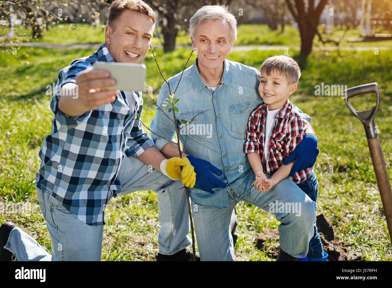 Father taking selfie with family members Stock Photo