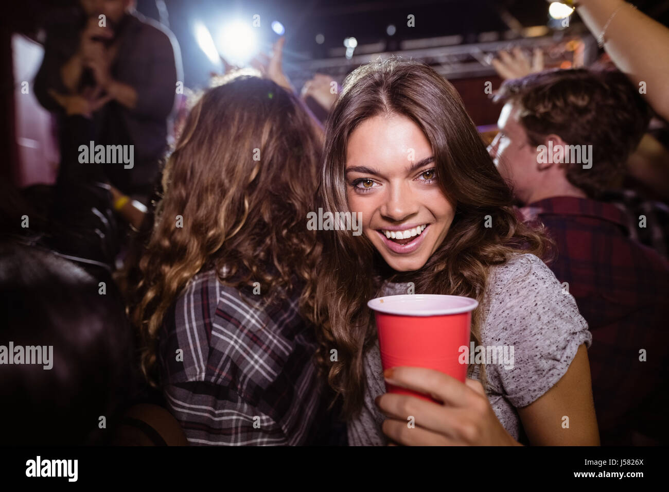 Portrait of happy woman enjoying music festival at nightclub Stock ...