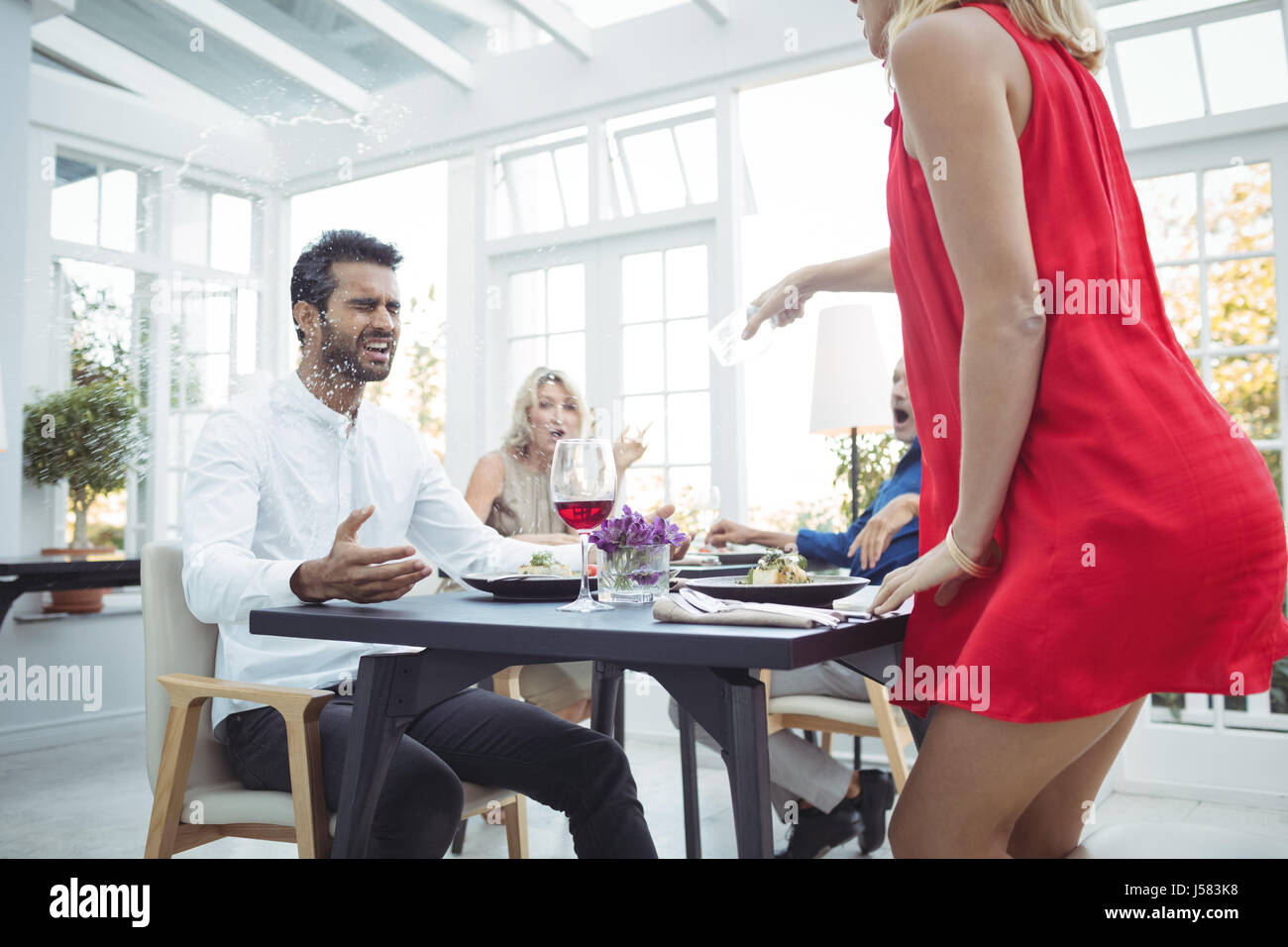 Man throwing drink in restaurant hires stock photography and images