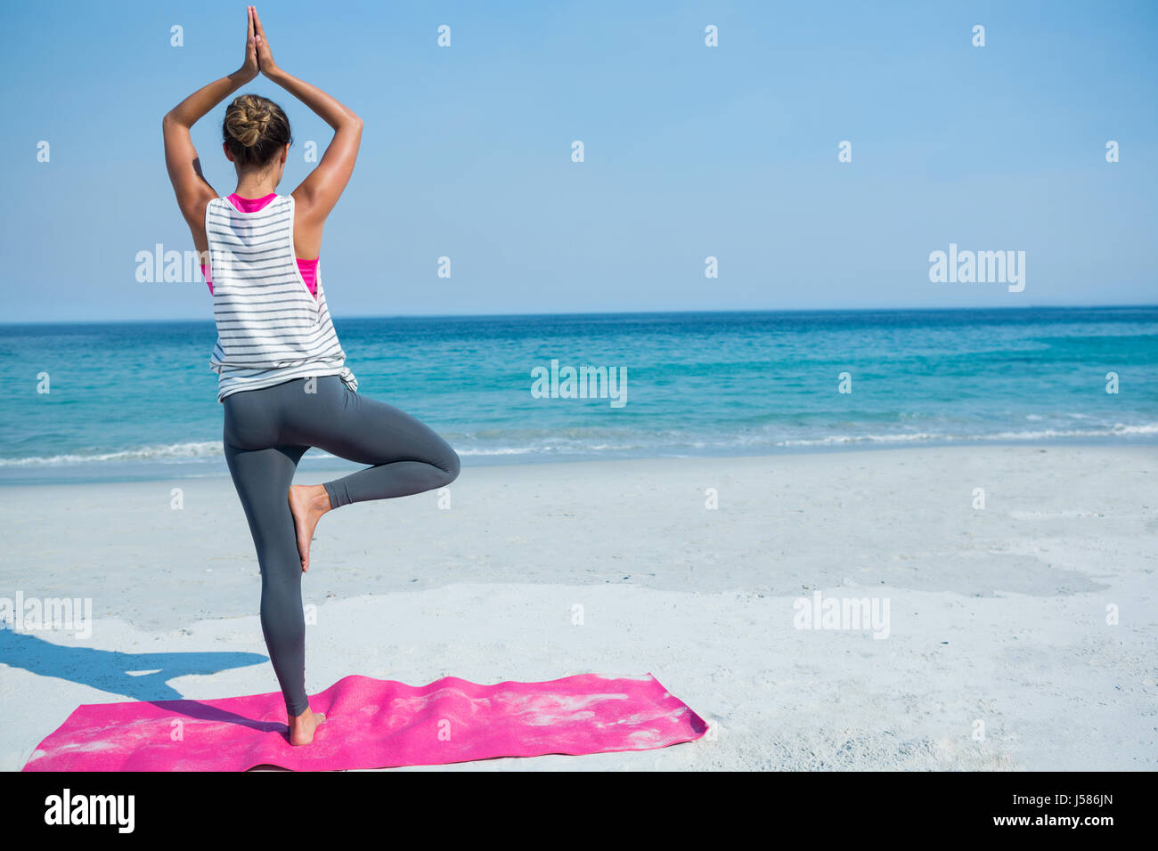 Woman practicing yoga tree pose hi-res stock photography and images - Alamy