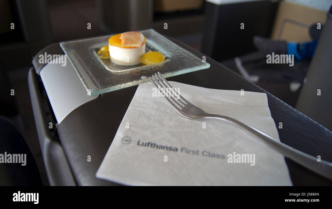 FRANKFURT, GERMANY - SEPTEMBER 28, 2014: First Class Dining onboard an Boeing 747 upper deck from Lufthansa, Amuse bouche: Trout bite with passion fruit and mango Stock Photo