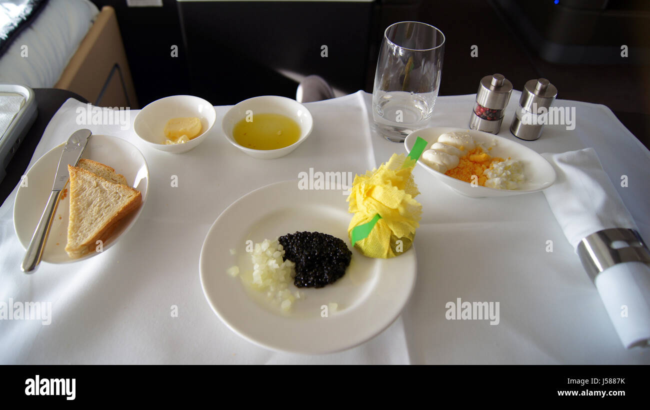 FRANKFURT, GERMANY - SEPTEMBER 2014: Traveling Lufthansa First Class in a Boeing 747-400 Upper Deck - Service with black caviar, Toast, onions and eggs Stock Photo