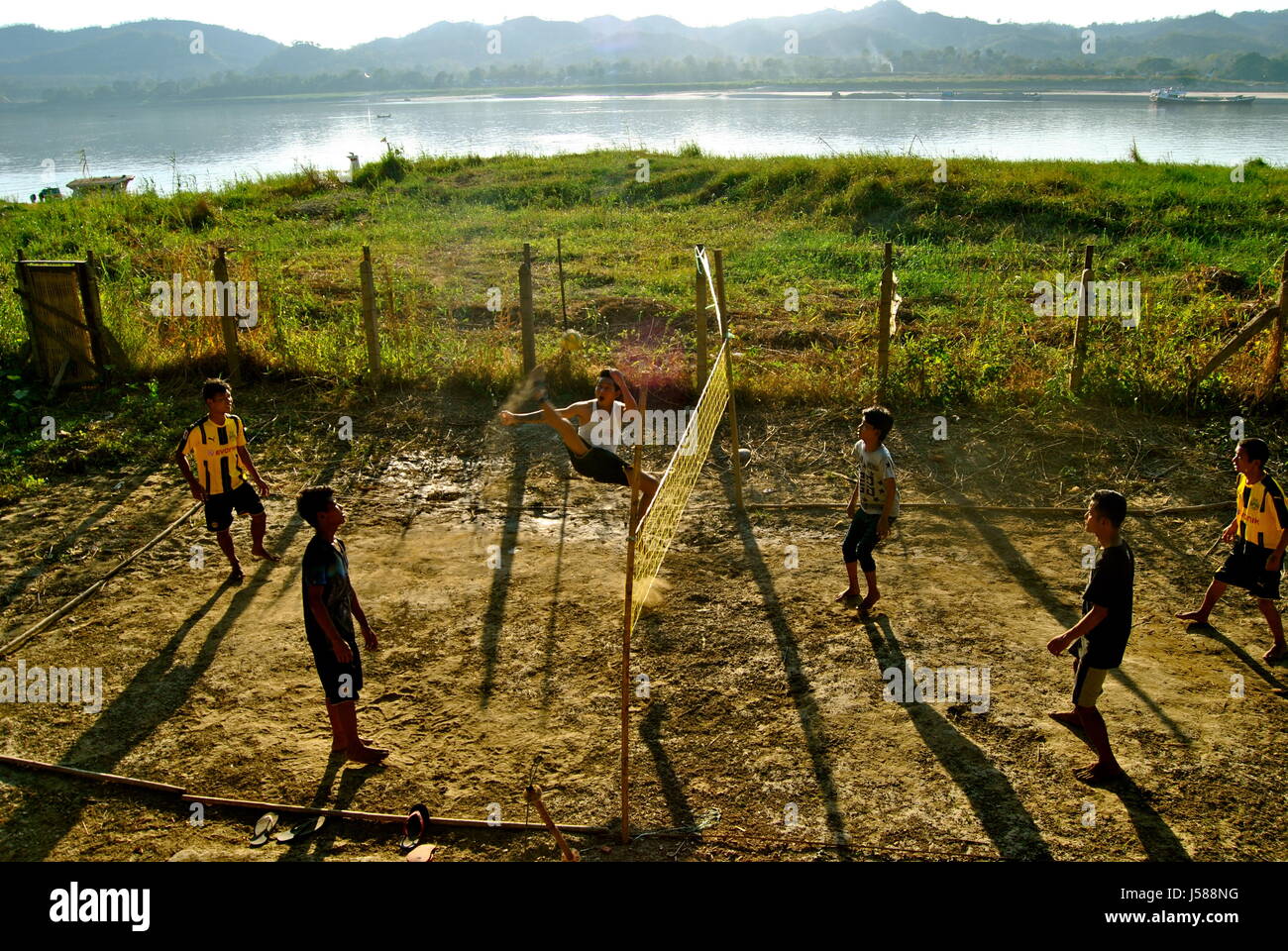 Young men playing sepak takraw near the Irrawaddy river, Pyay, Myanmar Stock Photo