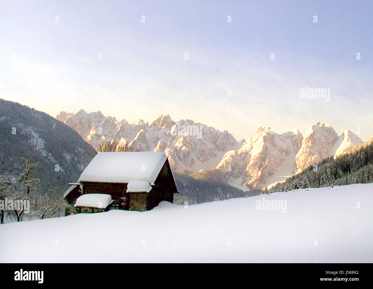 winter snowy red sky snow mountain nature gosau dachstein huette almhuette Stock Photo