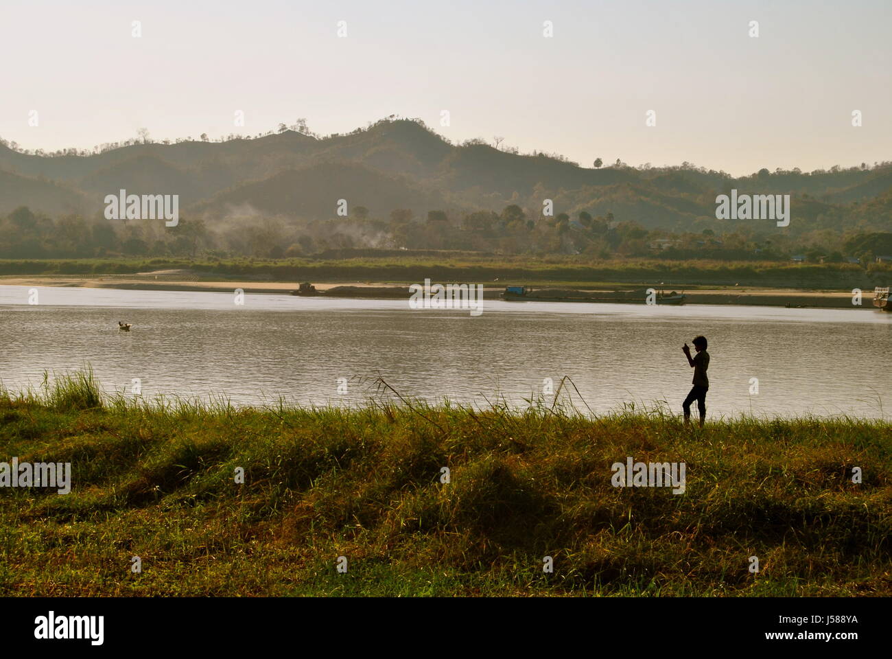 Boy Standing near the Irrawaddy river, Pyay, Myanmar Stock Photo