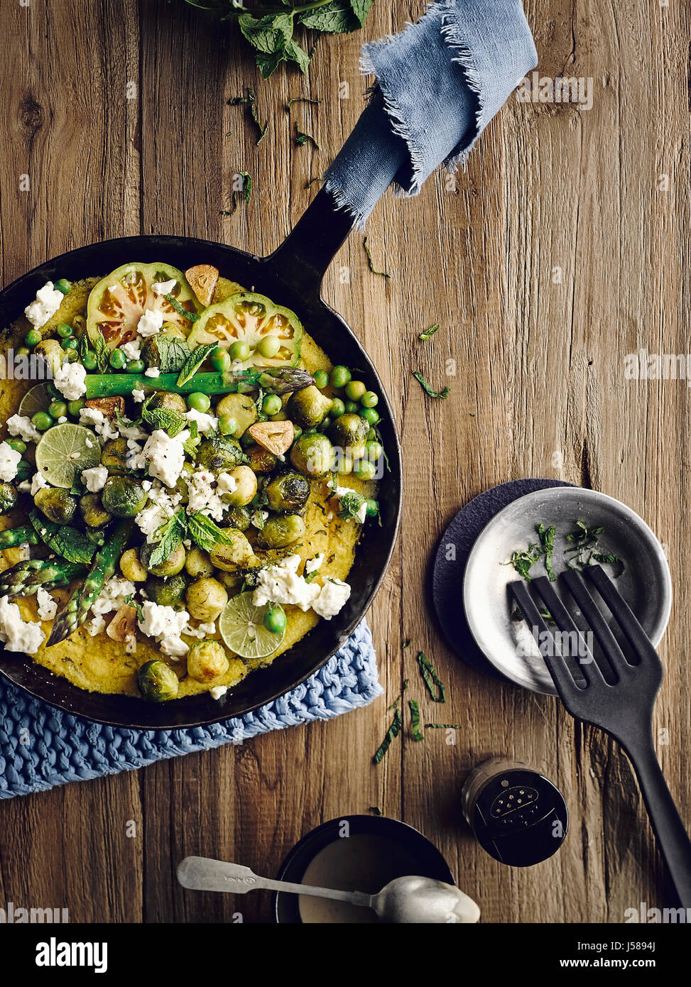 Mint polenta with brussel sprouts, goat cheese and sesame sauce Stock Photo