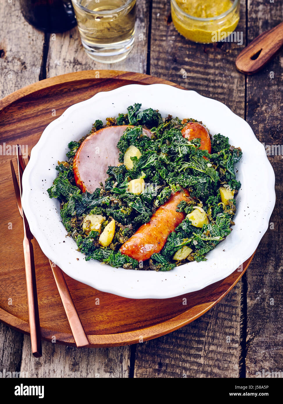Kale with cabbage sausage and gammon steak Stock Photo Alamy