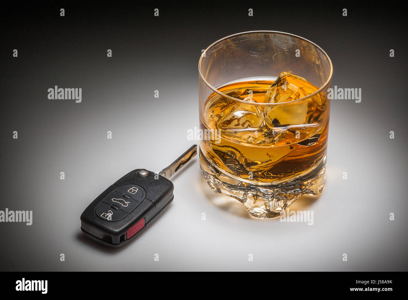 Drinking and driving concept with whiskey and car keys Stock Photo