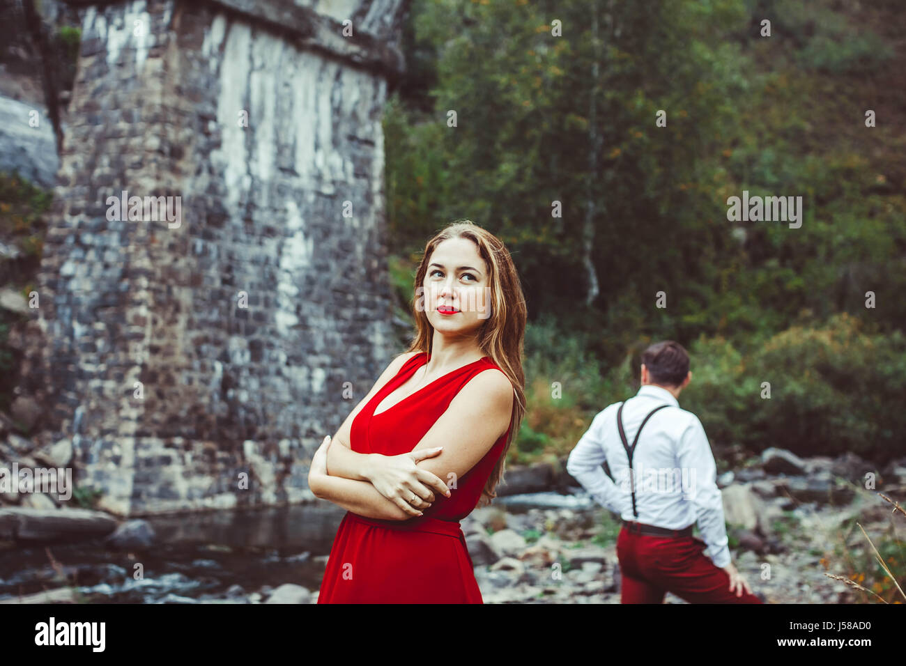 Couple standing in the nature, the girl in front Stock Photo - Alamy