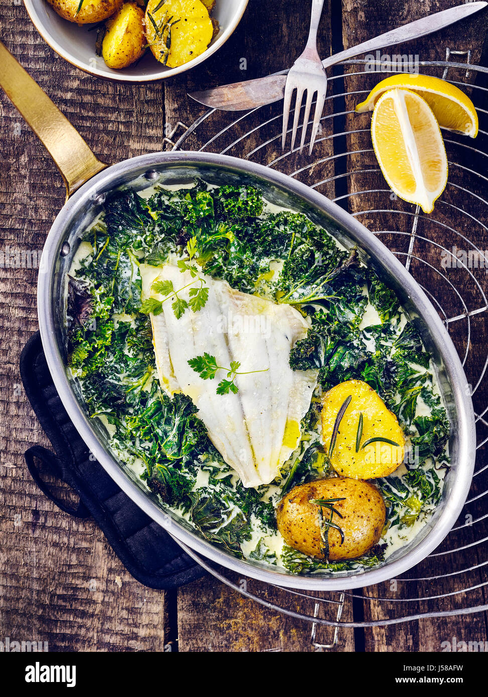 Filet of plaice with lemon kale and rosemary potatoes Stock Photo