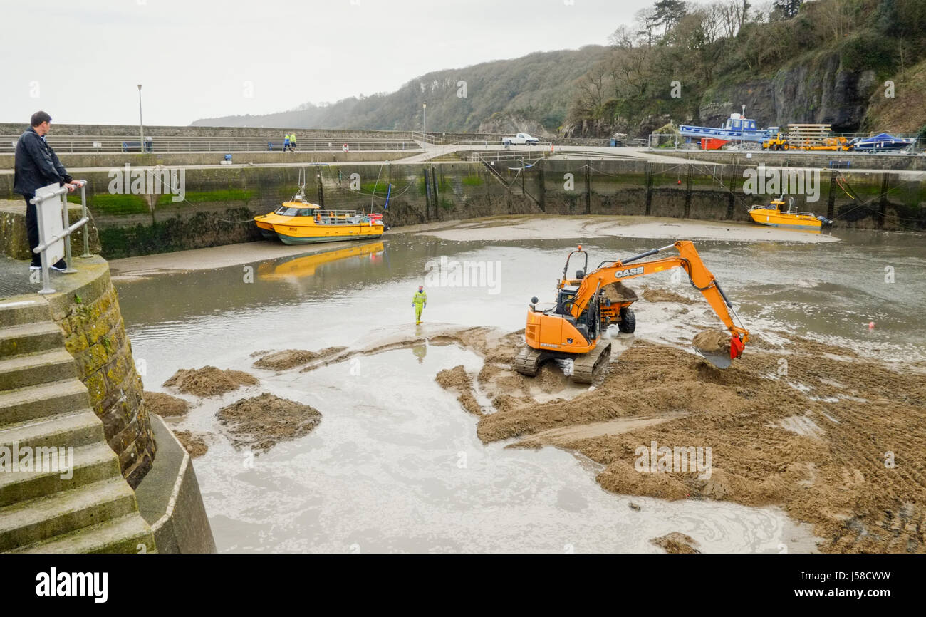 Saundersfoot Harbour maintenance. Heavy plant machinery assist in keeping the channel clear. Pembrokeshire,  west Wales. UK. Stock Photo