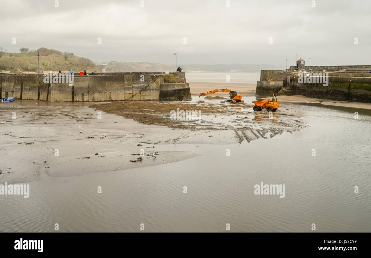 Saundersfoot Harbour maintenance. Heavy plant machinery assist in keeping the channel clear. Pembrokeshire,  west Wales. UK. Stock Photo