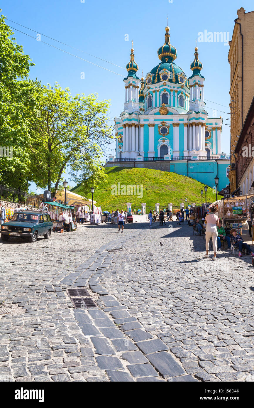 KIEV, UKRAINE - MAY 6, 2017: people on market on Andriyivskyy Descent and view of St Andrew's Church in Kiev city in spring. The church was constructe Stock Photo