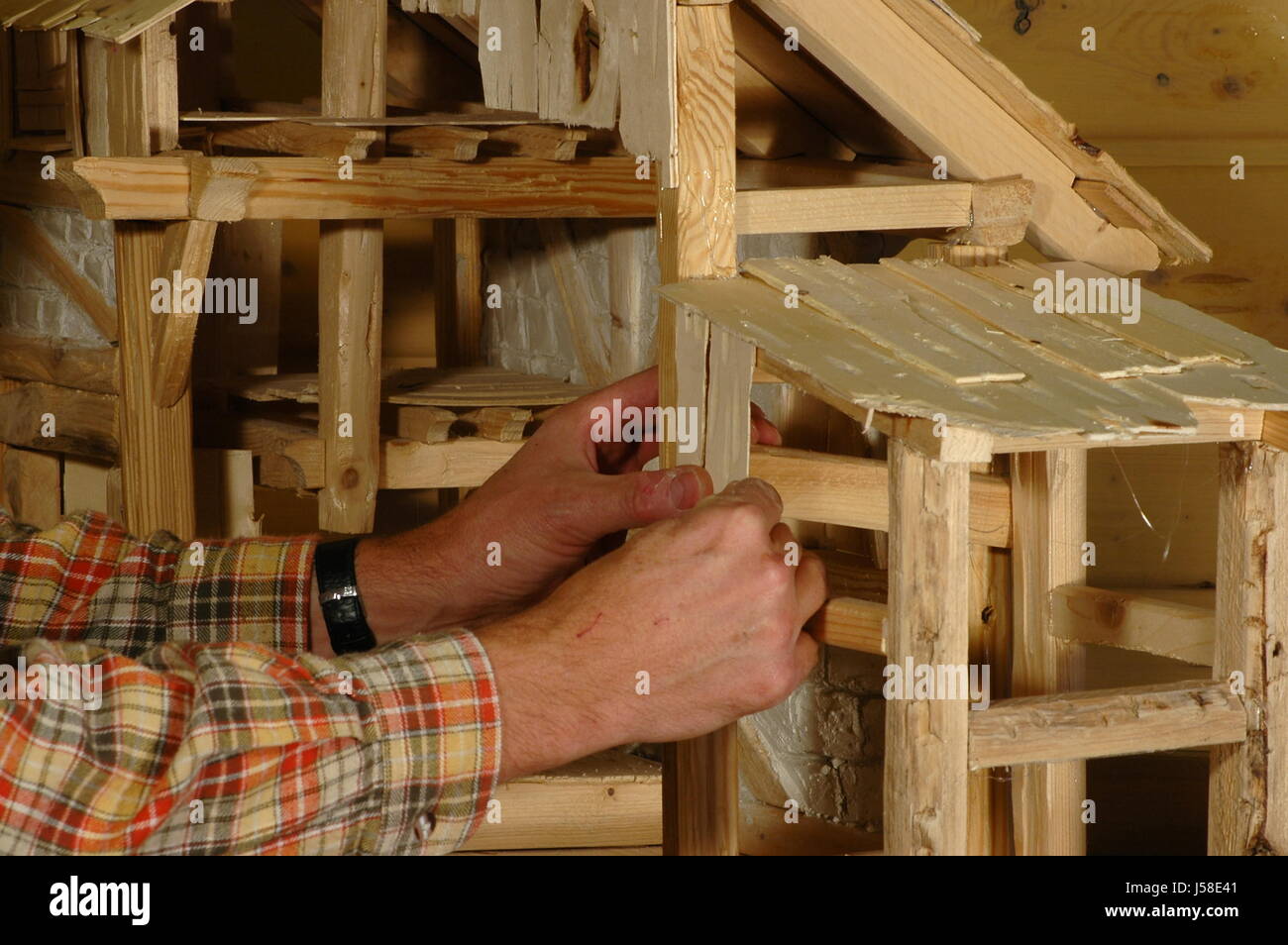 hand hands wood stable do handicrafts traditions advent season manger plywood Stock Photo
