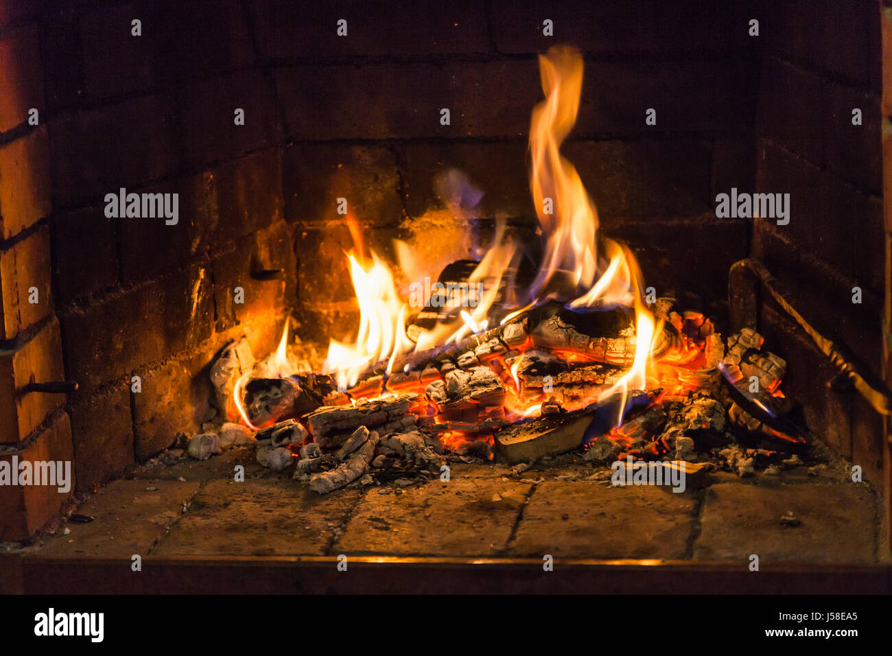 flame on woods in fireplace in country cottage Stock Photo