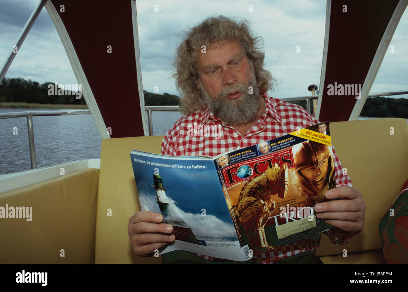 man with beard in the boat when reading Stock Photo - Alamy