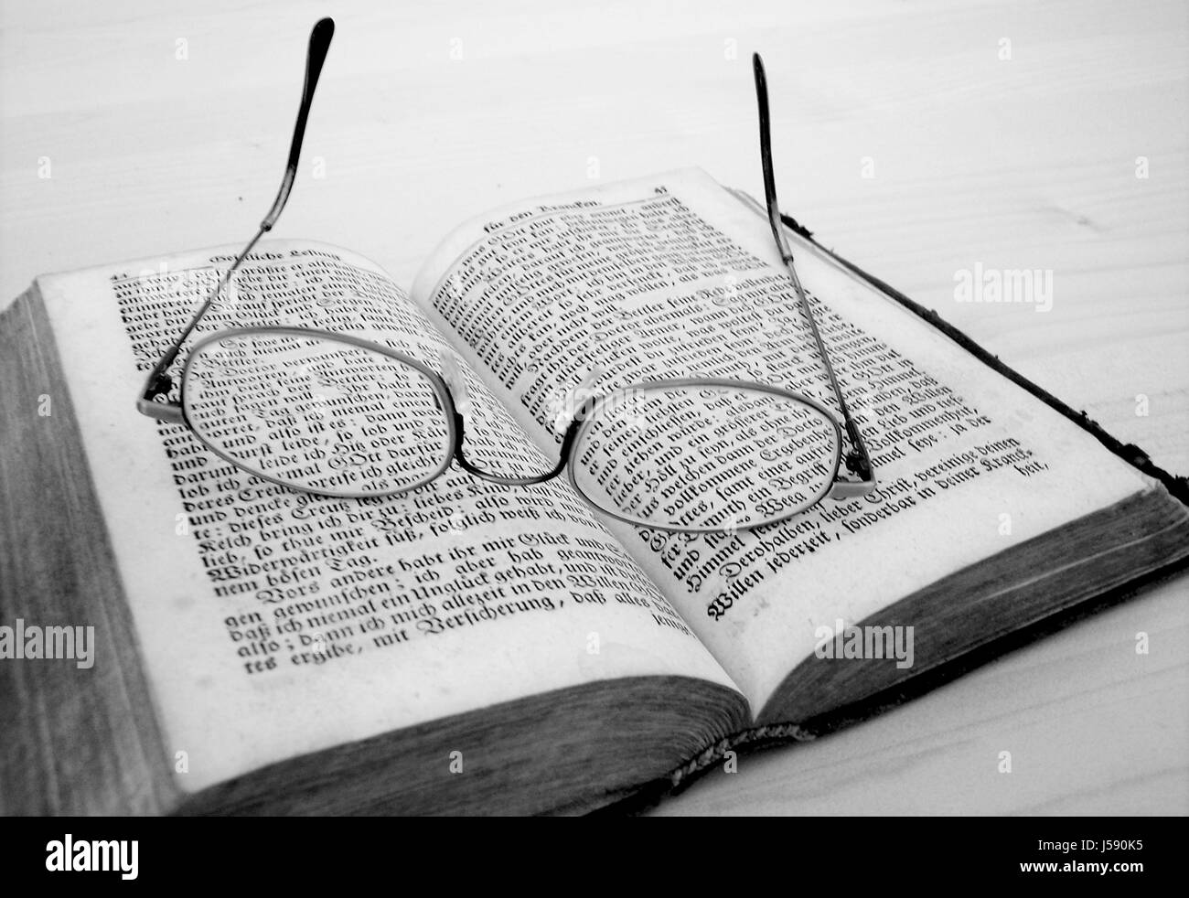 education religious antique bw writing font typography spectacles glasses Stock Photo