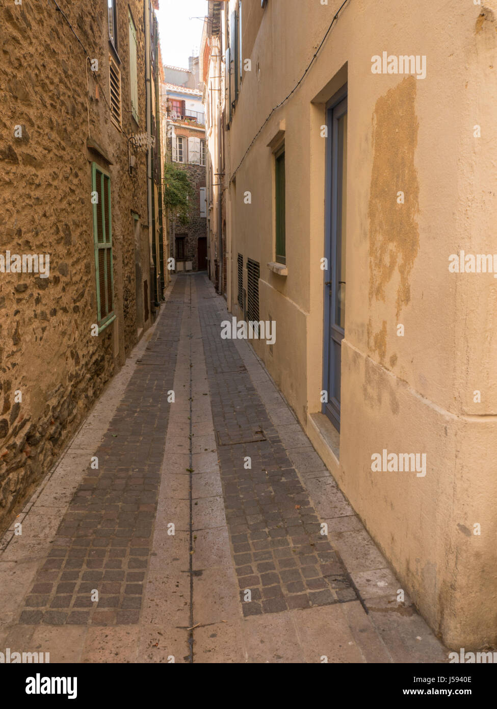 Narrow passage giving access to dwellings Stock Photo