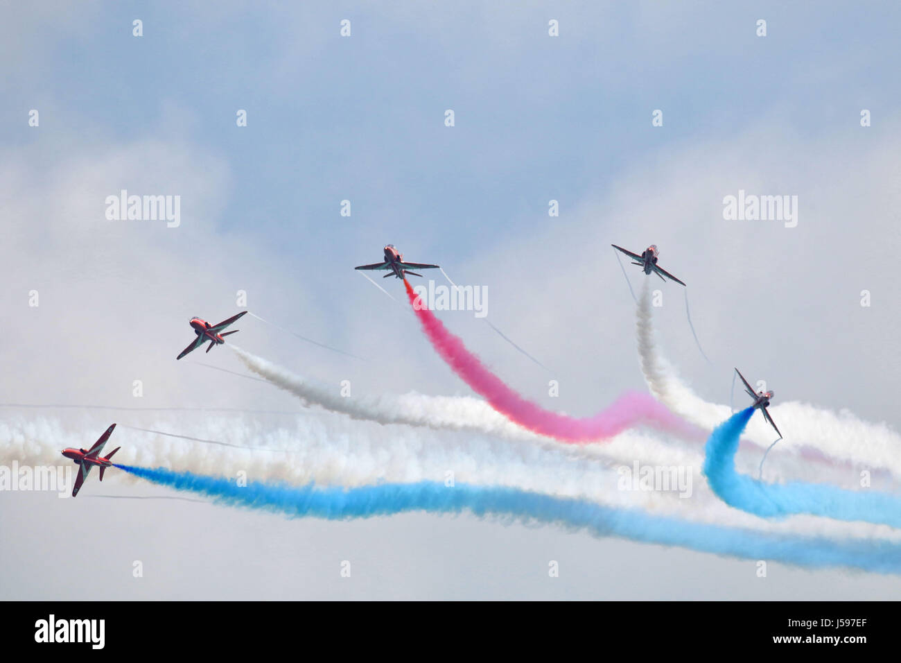 Red arrows aerobatic display team burst over Eastbourne UK Stock Photo