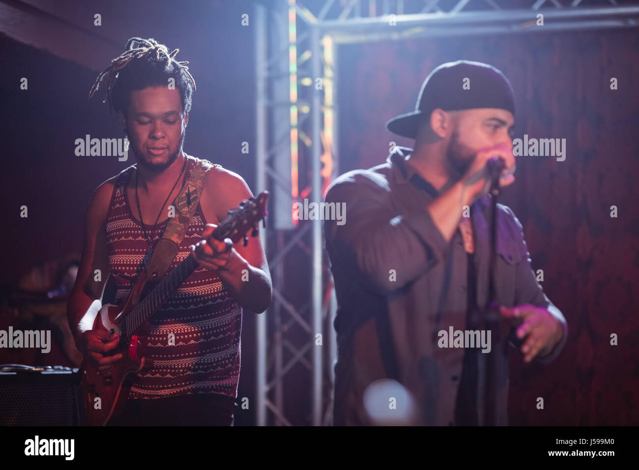 Musicians performing at nightclub during music concert Stock Photo