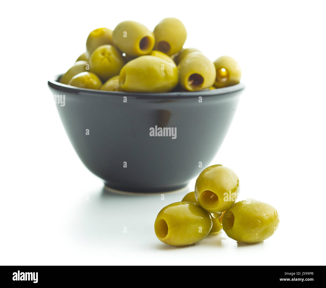 The green olives in bowl isolated on white background. Stock Photo