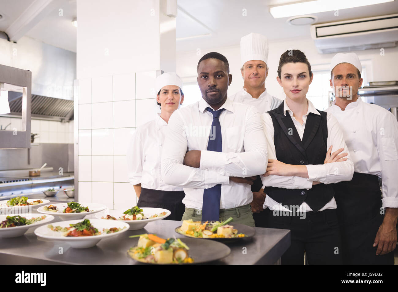 portrait of restaurant manager with his kitchen staff in the stock kitchen staff