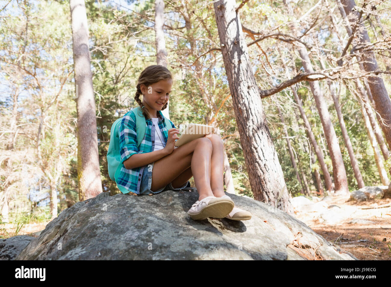 Pretty girl sitting on rock hi-res stock photography and images - Alamy